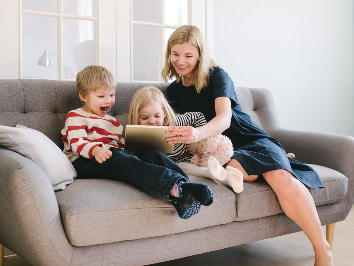 Mother and kids playing on tab